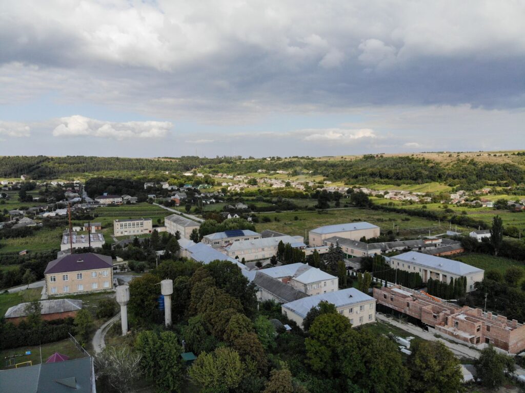 Aerial view of Більче-Золоте village, showcasing rural architecture and lush greenery.
