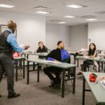 University classroom with students receiving instructions from a professor.