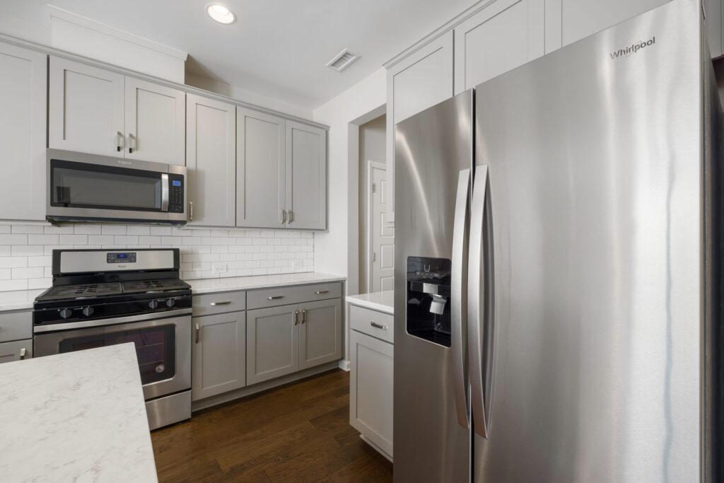 Sleek modern kitchen featuring stainless steel appliances and white cabinetry for a contemporary look.