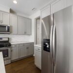 Sleek modern kitchen featuring stainless steel appliances and white cabinetry for a contemporary look.