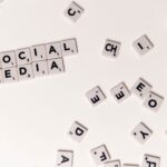 Scrabble tiles spelling 'Social Media' on a white background, symbolizing digital communication.