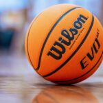 Orange basketball on a polished indoor gym floor, ready for play.