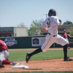 Two baseball players compete in an intense game at Harding University Stadium, showcasing sportsmanship and action.