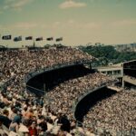 Historic view of a packed crowd at Melbourne Cricket Ground during an AFL match.