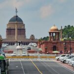 View of Rashtrapati Bhavan entrance and surrounding architecture with traffic.