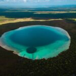 Breathtaking aerial view of Laguna de Kaan Luum near Tulum, showcasing vivid colors and natural beauty.