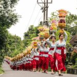 Women in traditional attire participate in a ceremonial procession in Gianyar, Bali, Indonesia.
