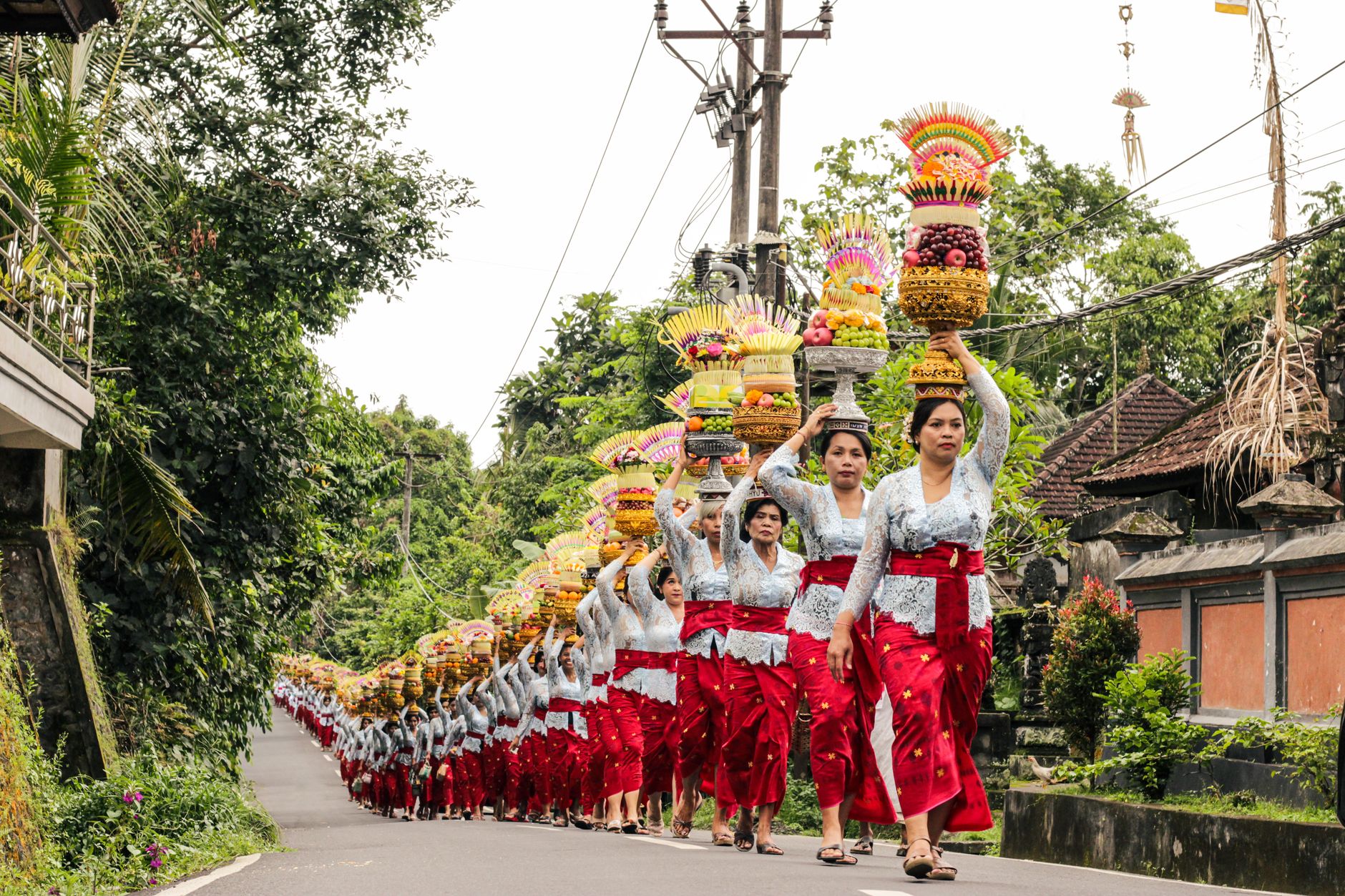 Women in traditional attire participate in a ceremonial procession in Gianyar, Bali, Indonesia.