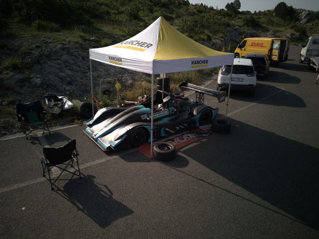 High-angle view of a racing car setup under a tent in Kruje, Albania.