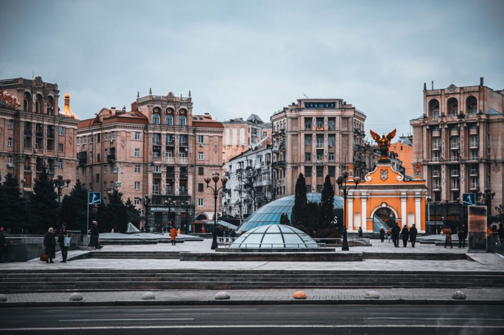Majestic view of Kyiv's Independence Square showcasing historic architecture and vibrant urban life.
